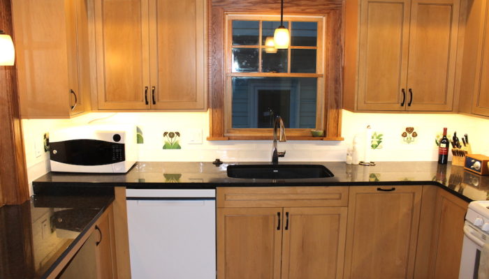 Kitchen sink and wood cabinets.